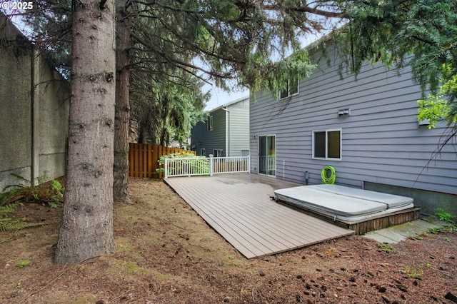 wooden deck with a covered hot tub