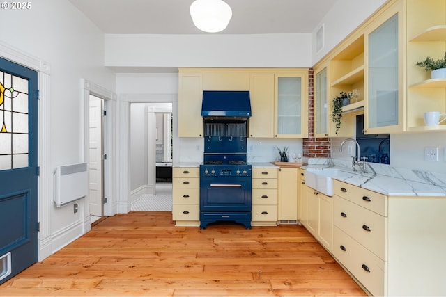 2664 NW Thurman St, Portland, OR 97210 - kitchen featuring a sink, light wood-style flooring, exhaust hood, open shelves, and light stone countertops
