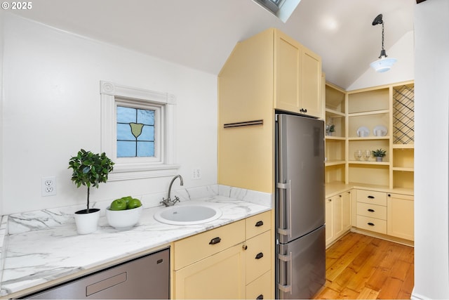 2664 NW Thurman St, Portland, OR 97210 - kitchen featuring freestanding refrigerator, a sink, light wood-style floors, decorative light fixtures, and lofted ceiling