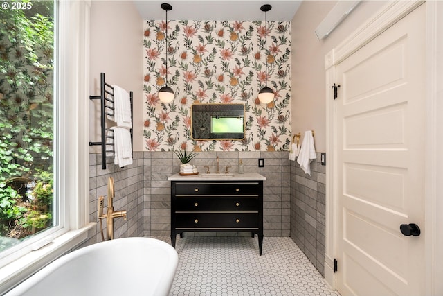2664 NW Thurman St, Portland, OR 97210 - bathroom featuring tile walls, a soaking tub, vanity, a wainscoted wall, and radiator