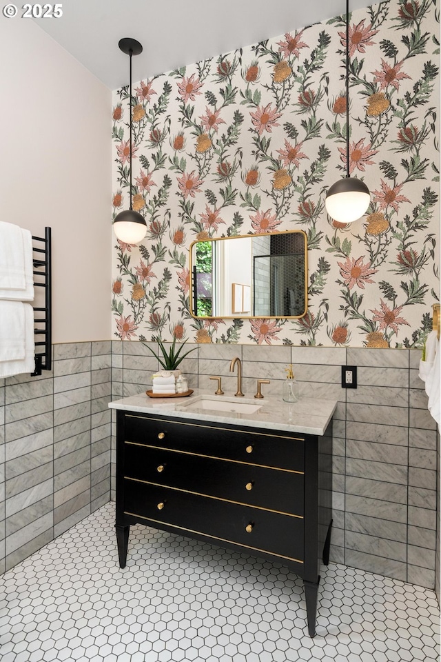 2664 NW Thurman St, Portland, OR 97210 - bathroom featuring wallpapered walls, vanity, wainscoting, tile walls, and tile patterned flooring