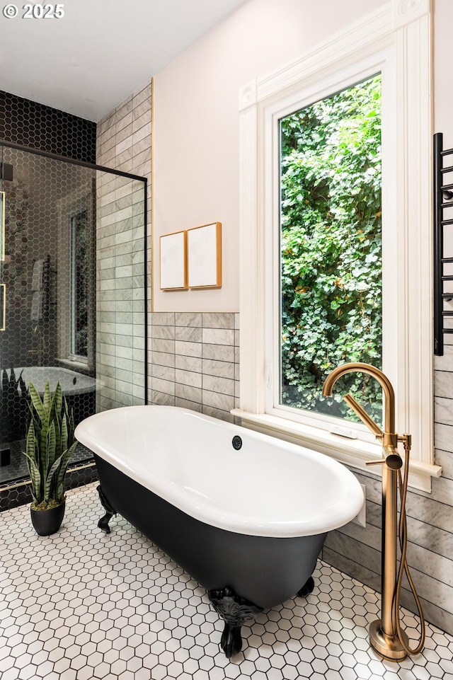 2664 NW Thurman St, Portland, OR 97210 - full bath featuring a freestanding tub, tile walls, a stall shower, and tile patterned flooring