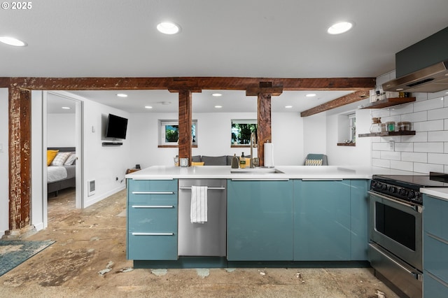 2664 NW Thurman St, Portland, OR 97210 - kitchen with appliances with stainless steel finishes, a sink, open shelves, blue cabinetry, and wall chimney range hood