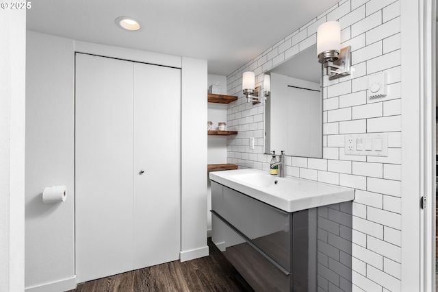 2664 NW Thurman St, Portland, OR 97210 - bathroom featuring vanity, wood finished floors, tile walls, baseboards, and recessed lighting