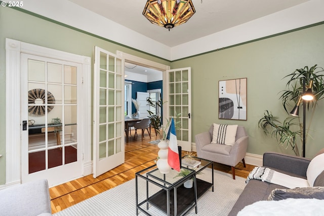 2664 NW Thurman St, Portland, OR 97210 - living area with french doors, a chandelier, and wood finished floors
