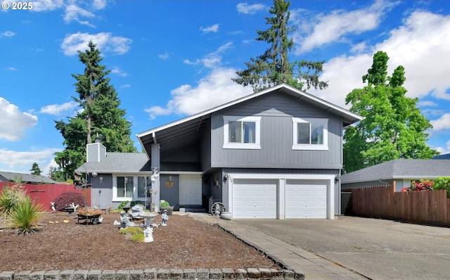 523 65th St, Springfield, OR 97478 - view of front of home with concrete driveway, a garage, and a chimney