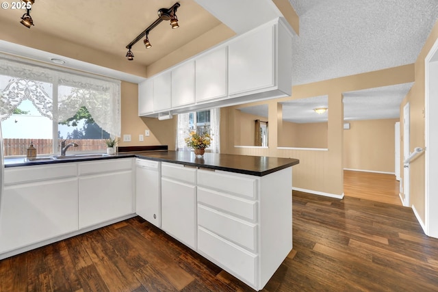 523 65th St, Springfield, OR 97478 - kitchen featuring white dishwasher, dark wood-style floors, and dark countertops