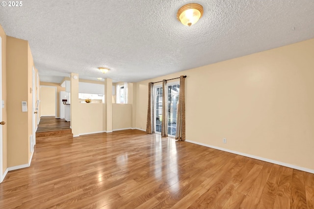 523 65th St, Springfield, OR 97478 - spare room featuring a textured ceiling, light wood-type flooring, and baseboards