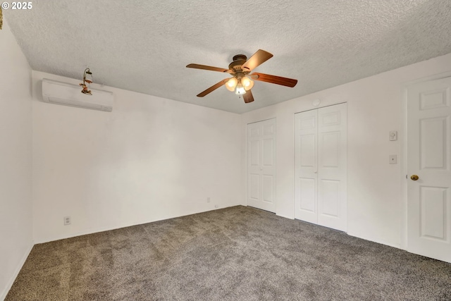 523 65th St, Springfield, OR 97478 - unfurnished bedroom with carpet, an AC wall unit, a textured ceiling, a ceiling fan, and two closets