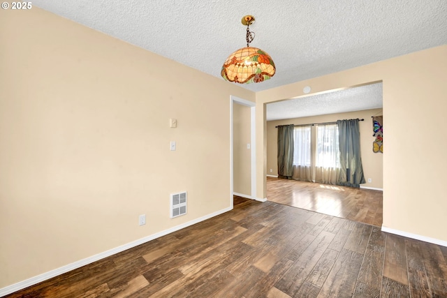 523 65th St, Springfield, OR 97478 - spare room featuring wood finished floors, a textured ceiling, and baseboards