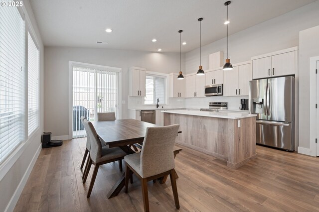 2417 NE 2nd Ct, Battle Ground, WA 98604 - dining space featuring wood finished floors, baseboards, recessed lighting, and vaulted ceiling