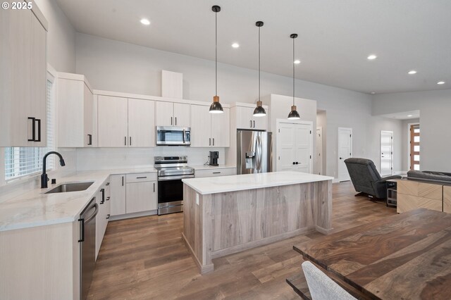 2417 NE 2nd Ct, Battle Ground, WA 98604 - kitchen with appliances with stainless steel finishes, a sink, a center island, wood finished floors, and recessed lighting
