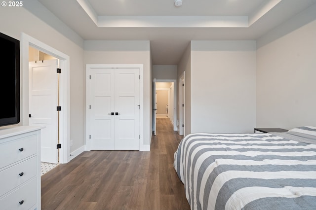 2417 NE 2nd Ct, Battle Ground, WA 98604 - bedroom with a tray ceiling, dark wood-style flooring, baseboards, and a closet