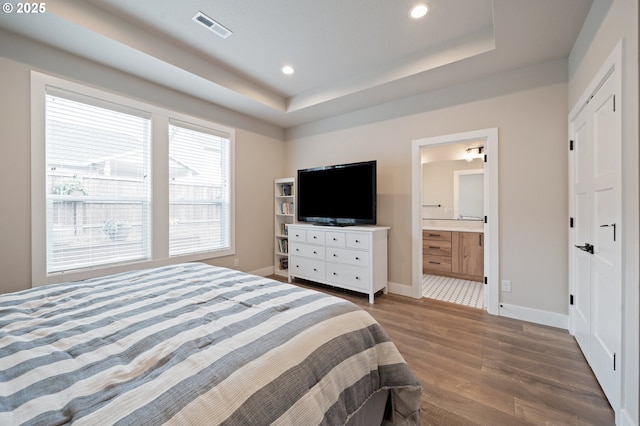 2417 NE 2nd Ct, Battle Ground, WA 98604 - bedroom with wood finished floors, baseboards, recessed lighting, a tray ceiling, and ensuite bathroom