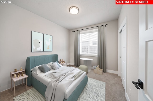 2417 NE 2nd Ct, Battle Ground, WA 98604 - carpeted bedroom featuring baseboards and a textured ceiling