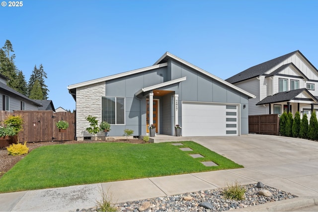 2417 NE 2nd Ct, Battle Ground, WA 98604 - view of front facade with board and batten siding, an attached garage, concrete driveway, and stone siding