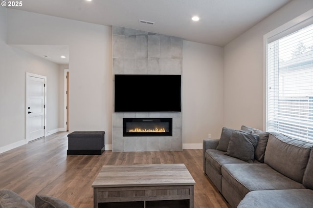 2417 NE 2nd Ct, Battle Ground, WA 98604 - living room with wood finished floors, a tile fireplace, recessed lighting, and baseboards