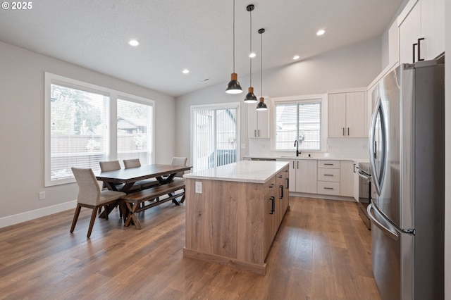 2417 NE 2nd Ct, Battle Ground, WA 98604 - kitchen featuring appliances with stainless steel finishes, a center island, recessed lighting, lofted ceiling, and light countertops