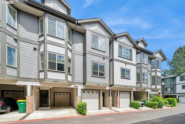 view of building exterior with a garage and a residential view