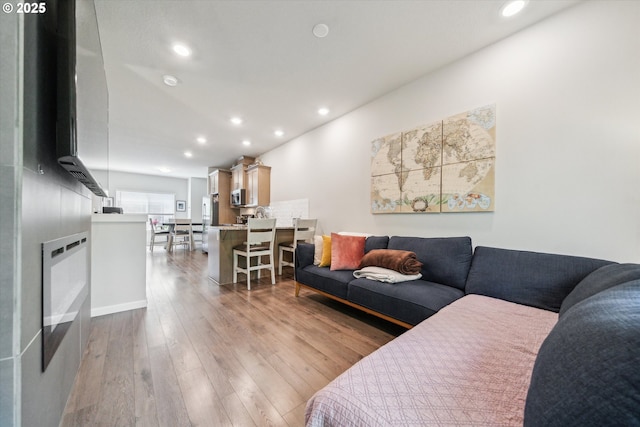 living area featuring recessed lighting and hardwood / wood-style flooring