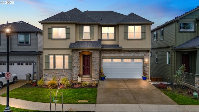 view of front of home featuring stone siding, stucco siding, a garage, and roof with shingles