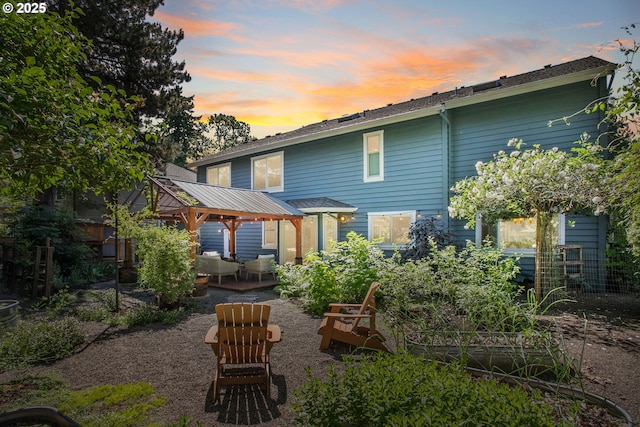 13555 SW Hiteon Ct, Beaverton, OR 97008 - back of property at dusk featuring a gazebo and a patio