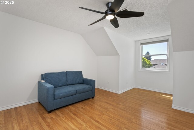 13555 SW Hiteon Ct, Beaverton, OR 97008 - unfurnished room featuring wood finished floors, a textured ceiling, ceiling fan, baseboards, and lofted ceiling