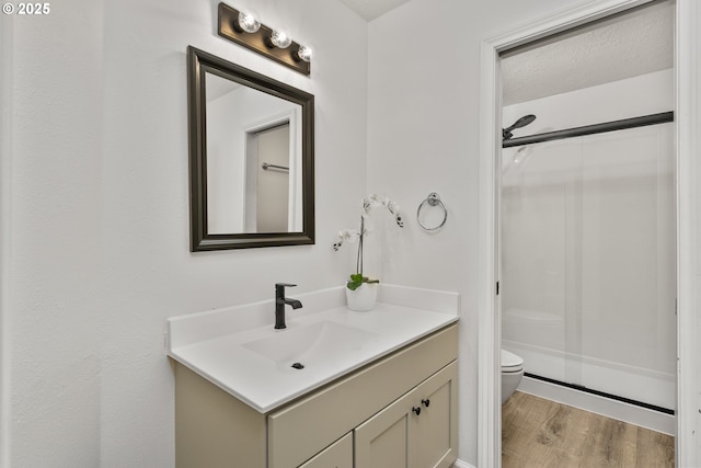 13555 SW Hiteon Ct, Beaverton, OR 97008 - full bathroom with vanity, a shower stall, and wood finished floors