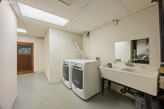 laundry area featuring laundry area, washer and clothes dryer, and a sink