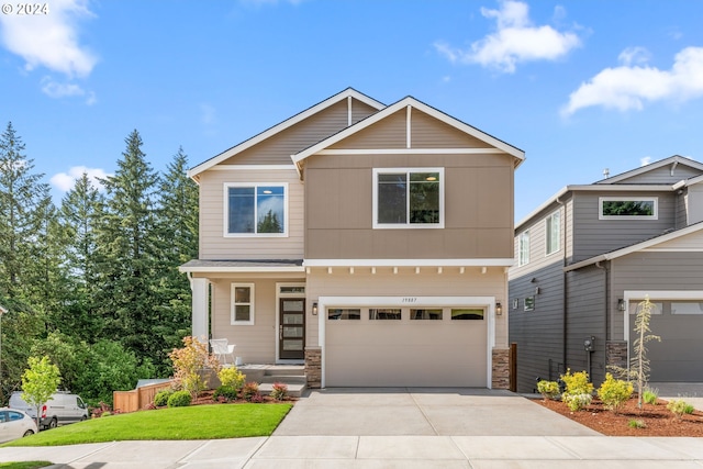 craftsman-style house featuring a garage and a front yard