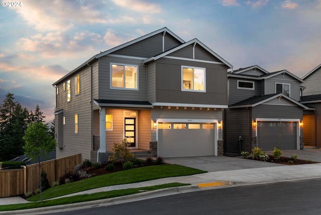 view of front of house featuring a garage and a yard