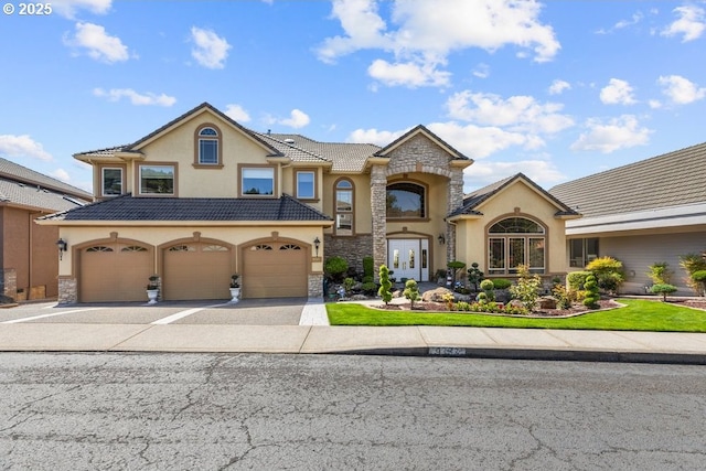 9337 SE Pennington Ct, Happy Valley, OR 97086 - view of front facade featuring stucco siding, asphalt driveway, stone siding, a garage, and a tile roof