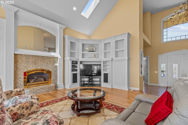 9337 SE Pennington Ct, Happy Valley, OR 97086 - living room featuring high vaulted ceiling, a high end fireplace, wood finished floors, and a skylight
