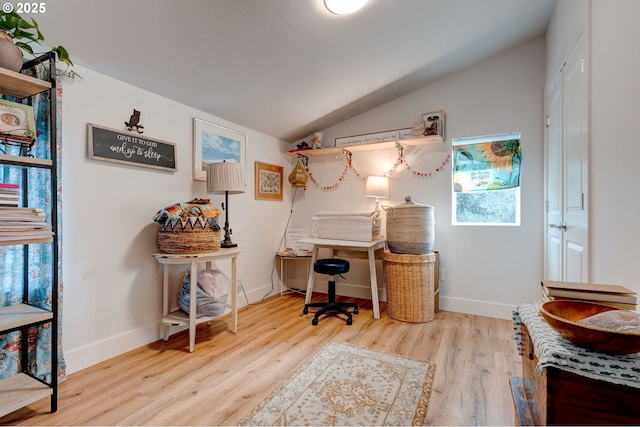 office featuring vaulted ceiling and light hardwood / wood-style flooring