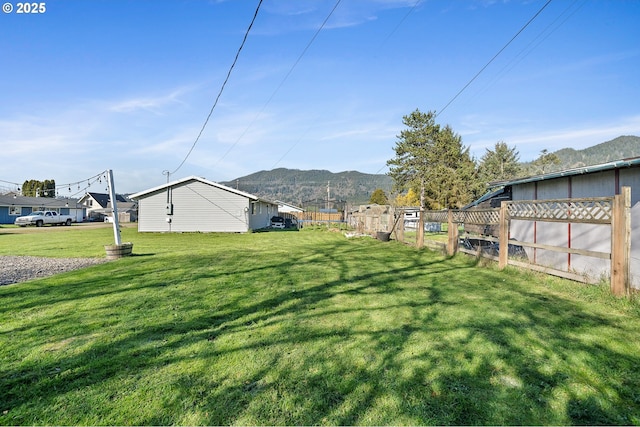 view of yard with a mountain view and fence