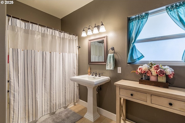 bathroom featuring baseboards and tile patterned floors