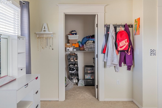 spacious closet with light colored carpet