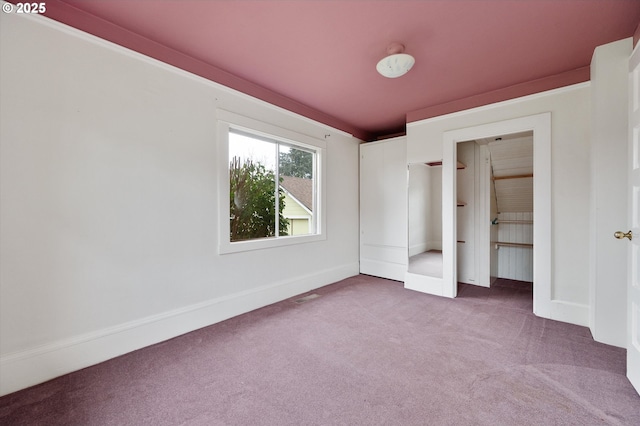 unfurnished bedroom with carpet floors and a closet