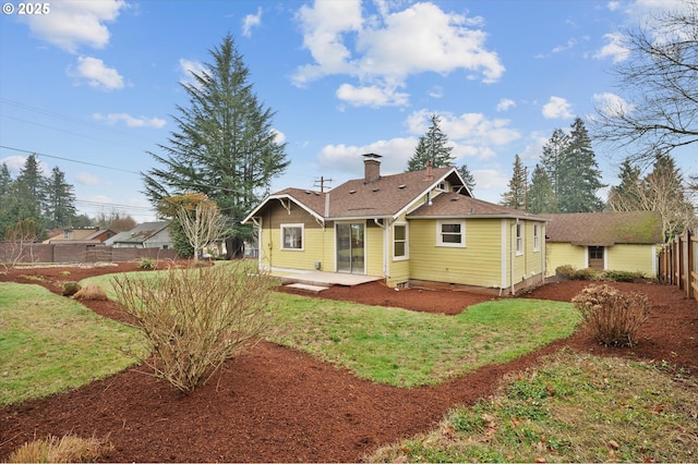 rear view of house featuring a lawn and a patio area