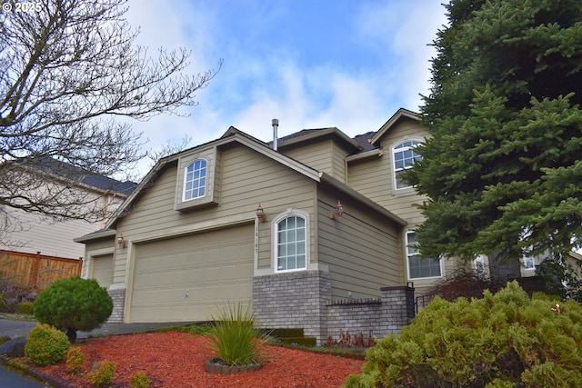 view of side of property with a garage and brick siding