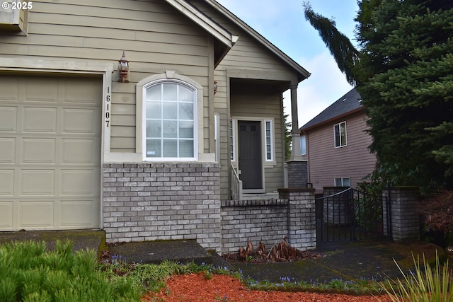 exterior space featuring brick siding and a garage