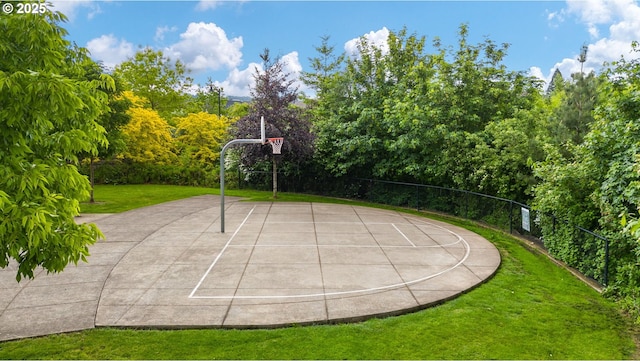 view of sport court featuring a lawn and community basketball court