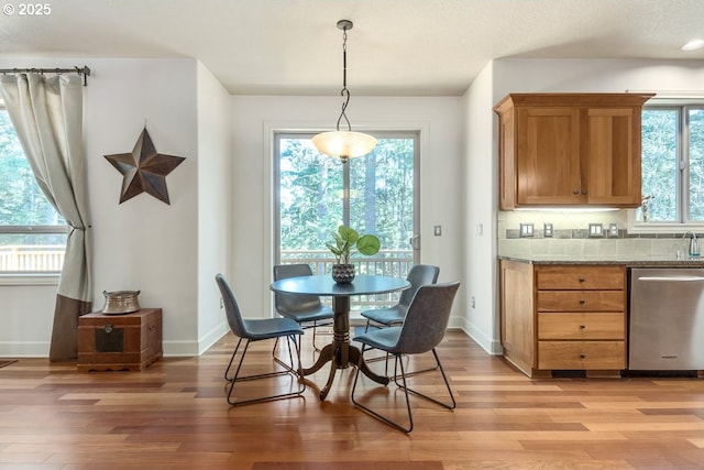 dining room featuring baseboards and light wood-style floors