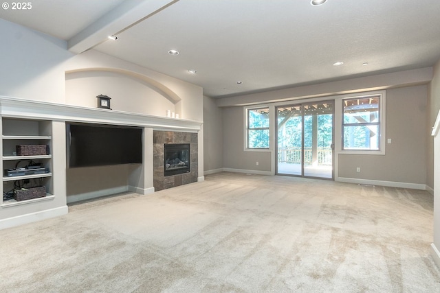 unfurnished living room featuring recessed lighting, baseboards, carpet floors, and a fireplace