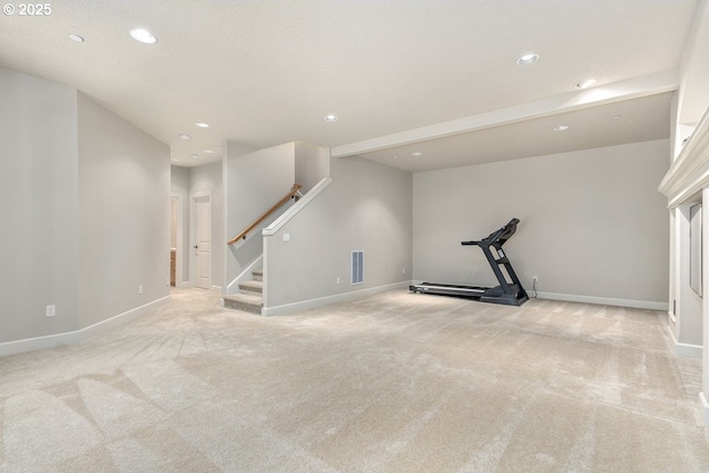 workout room featuring visible vents, light colored carpet, and baseboards