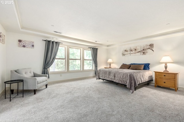 bedroom with crown molding, a raised ceiling, baseboards, and carpet floors