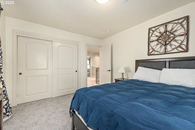 bedroom featuring a closet, a textured ceiling, and carpet floors