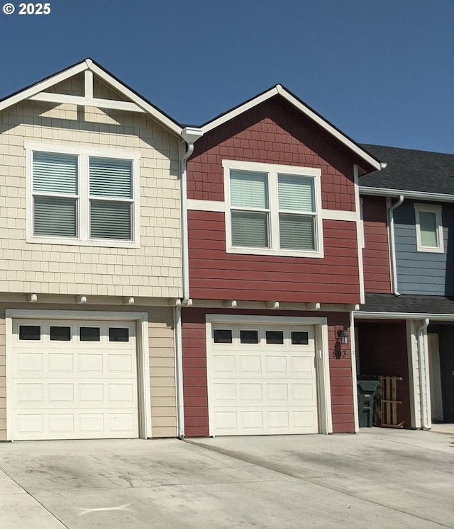 view of property featuring a garage and driveway