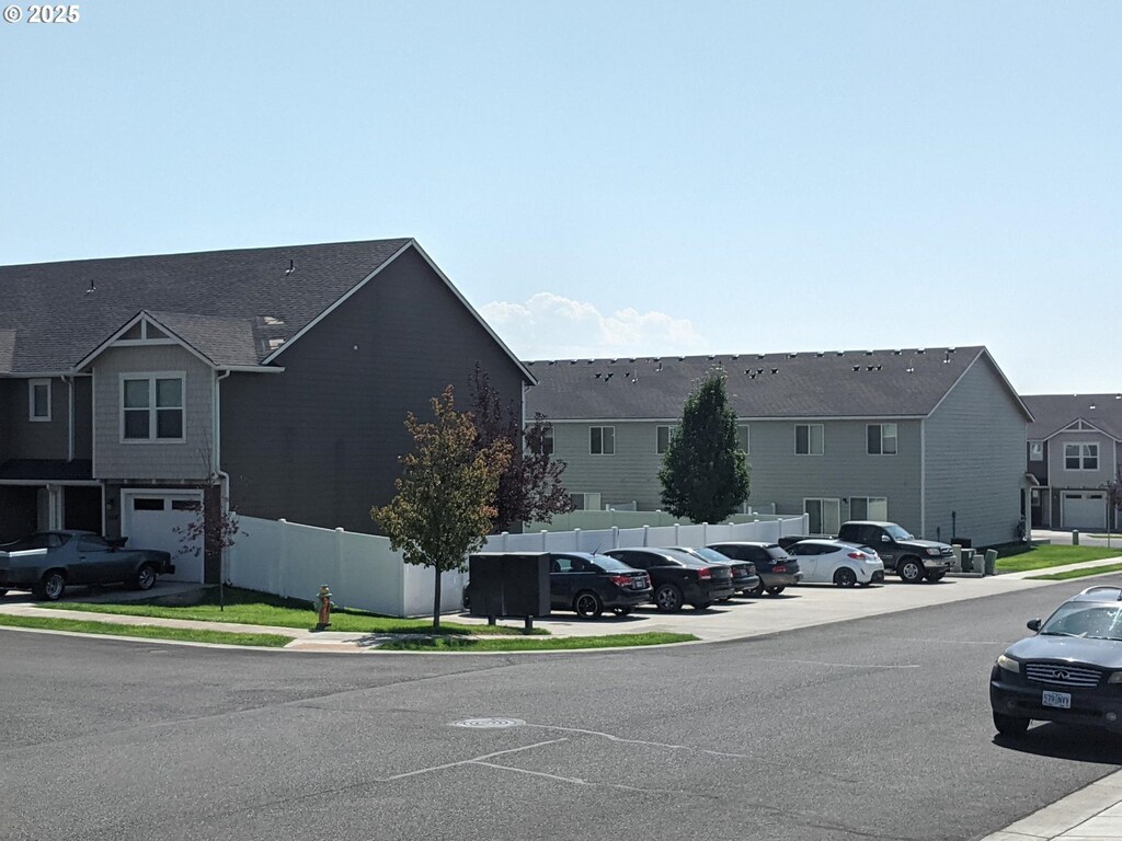 exterior space with a residential view, curbs, and sidewalks