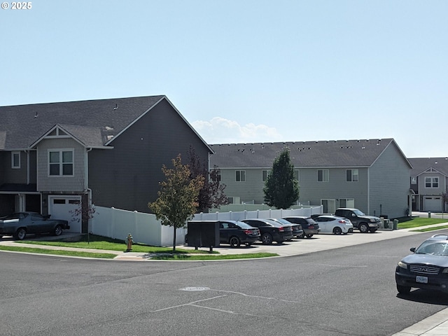 exterior space with a residential view, curbs, and sidewalks
